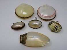 A collection of sea shell trinket boxes, three made from clam shells and three made from sections of