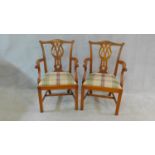 A pair of Chippendale style mahogany open armchairs with carved back splats and drop in seats on