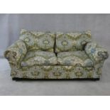 A two seater sofa in sage and pale blue floral upholstery. H.76xW.175xL.100cm