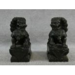 A pair of Chinese carved greenstone seated Dogs of Fo figures. H.23cm