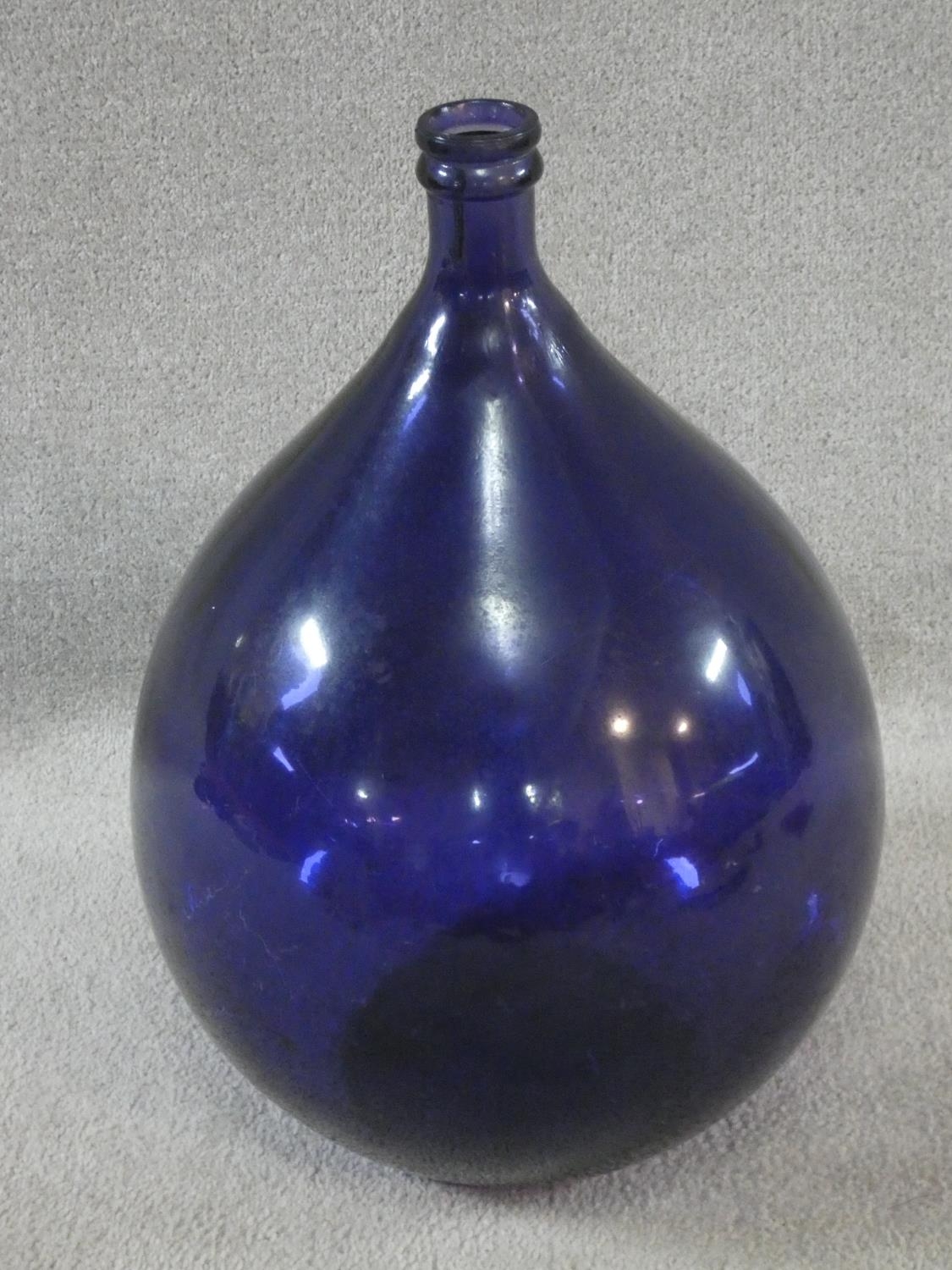 A Pols Potten Danish dark blue glass demijohn. H.55cm
