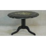 A Victorian papier mache tilt top occasional table hand painted with a floral spray and inlaid