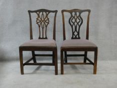 A near pair of Georgian mahogany dining chairs with pierced back splats and drop in seats on