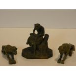 An antique brass monkey figure sitting on a tree stump with another below and a pair of brass