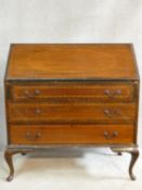 A Edwardian mahogany and satinwood inlaid bureau with fitted interior on cabriole supports. H.99 W.