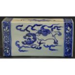 A Chinese ceramic flower brick with pierced top and blue and white dragon decoration in floral