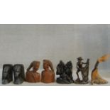 A collection of African hard wood carvings to include two pairs of head and shoulder studies, a
