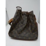 A Louis Vuitton style, Sac Noe bag with tan leather handle and drawstring closure. H.26cm