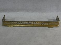 A 19th century pierced brass fire fender resting on stepped bracket feet. H.14xW.118xL.30cm