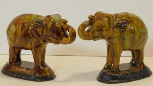 A pair of 19th century drip glazed bookends in the form of two elephants. H.17cm