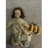 An antique German Armand Marseille bisque head girl doll, marked Made in Germany and with serial