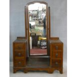 A mid century vintage oak twin pedestal dressing table fitted with central swing cheval mirror
