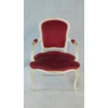 A white painted Louis XV style open armchair in burgundy velour upholstery. H.86cm