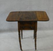 A Regency mahogany Pembroke work table fitted with two frieze drawers opposing dummy drawers on