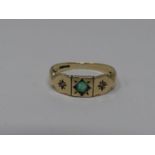 An antique diamond and emerald set 9ct gold ring. Set to centre with a round mixed cut emerald in
