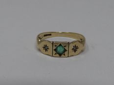 An antique diamond and emerald set 9ct gold ring. Set to centre with a round mixed cut emerald in