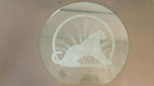 An Art Deco style glass sculptured and engraved glass panel of a seated panther, signed Mark