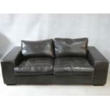 A vintage style brown leather down filled Collins & Hayes upholstered two seater sofa. H.70 W.202