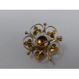 An antique yellow metal, pearl and diamond set pierced floral and foliate design brooch/pendant. Set