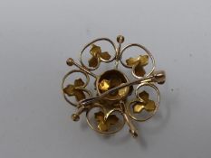 An antique yellow metal, pearl and diamond set pierced floral and foliate design brooch/pendant. Set