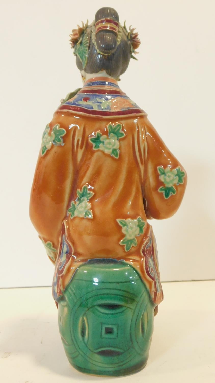 A Japanese ceramic figure of a lady sitting on a garden seat in polychrome hand painted decoration - Image 6 of 8