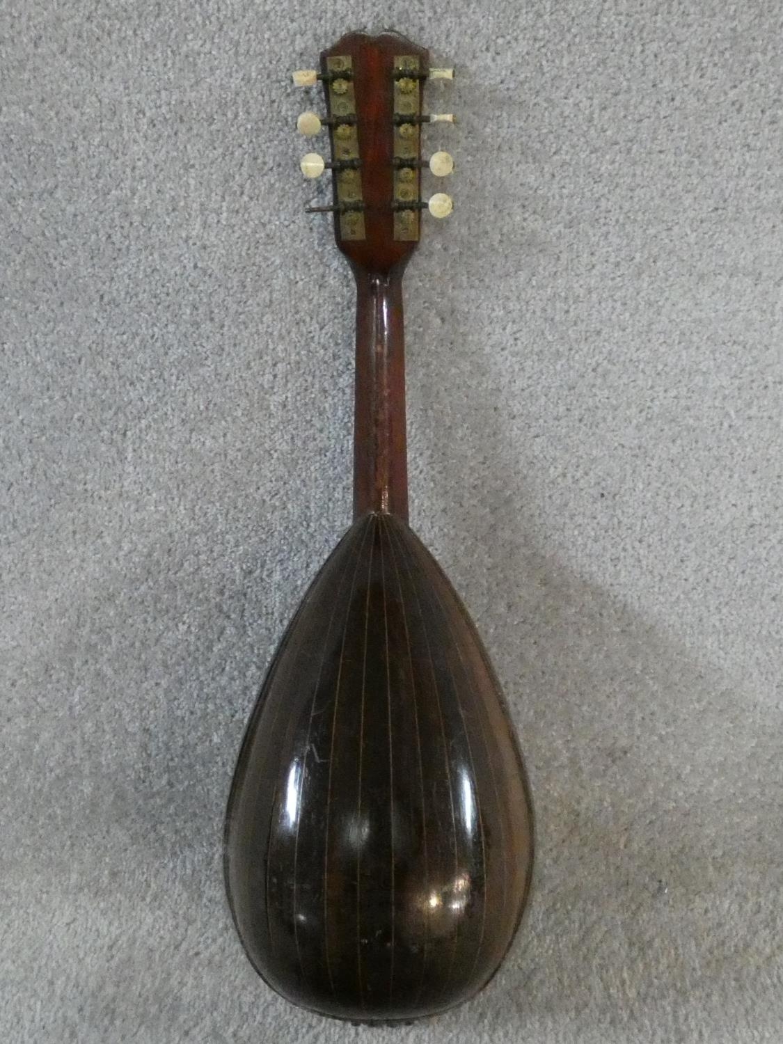 An early 20th century mandolin with mother of pearl and tortoiseshell inlay, signed Ozelli and - Image 7 of 13