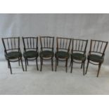 A set of six bentwood café style dining chairs with spindle backs and undulating hoop stretchered