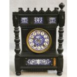 A late 19th century ebonised Gothic style bracket clock with blue and white ceramic dial and