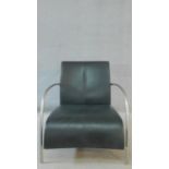 A vintage style leather armchair in black leather upholstery on metal tubular frame. 71cm