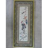 A framed and glazed Chinese panel, storks and foliate decoration within a stylized flowerhead