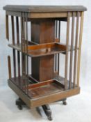 An Edwardian mahogany revolving bookcase with satinwood stringing and central inlaid fan roundel