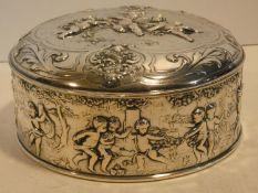 A Continental white metal hinged lidded caddy with gilded interior decorated with repousse repeating