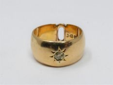 An antique 18 carat yellow gold gypsy ring set to centre with a round old cut diamond in a open back