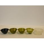 A set of four Chinese carved Spinach Jade flared rim, footed bowls along with a banded alabaster