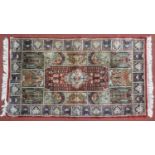 A Bachtiar rug with central pole medallion on burgundy ground within floral panels. 62x112cm