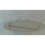 A mid century Hall's Galvo flattened ellipse space age style mirror. 122x30cm