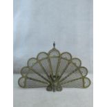 A 19th century brass peacock fire screen with nine adjustable pierced panels. H.65cm