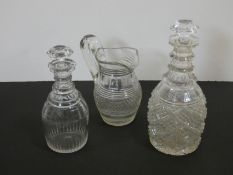 Two antique cut crystal decanters and a crystal cross hatched design jug. H.28cm