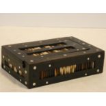 An ebonised lidded jewellery box with inlaid porcupine quills. H.5 W.17 D.11cm