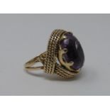 A 9 ct carat yellow gold and amethyst dress ring. Set with an oval mixed cut amethyst in an eight