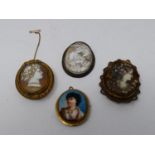 A collection of antique brooches and pendants. Including two craved shell cameos with classical