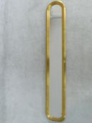 A narrow pier mirror in arched moulded gilt frame. H.105cm