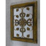 A gilt framed wall mirror with metal grille with husk and scrolling floral decoration H.65xW.52cm