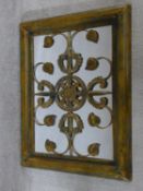 A gilt framed wall mirror with metal grille with husk and scrolling floral decoration H.65xW.52cm