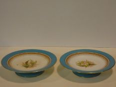 A pair of 19th century Royal Worcester comports with pale blue and gilt detailed rims and hand