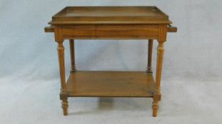 A late 19th century French walnut washstand with galleried top and towel rails on turned reeded