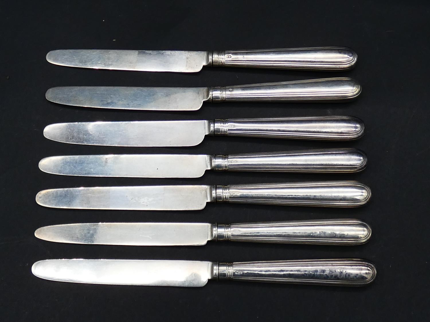 A set of seven antique silver fruit knives, handles and blades hallmarked, four marked Samuel Hennel