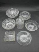 A collection of cut and pressed glass bowls and a star cut glass honey jar with lid. H.19cm