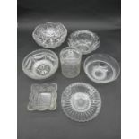 A collection of cut and pressed glass bowls and a star cut glass honey jar with lid. H.19cm