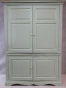 A large 19th century painted housekeeper's cupboard with fielded panel doors enclosing shaped fitted